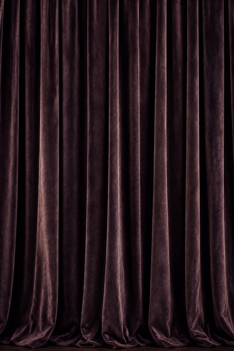 A closed dark velvet curtain